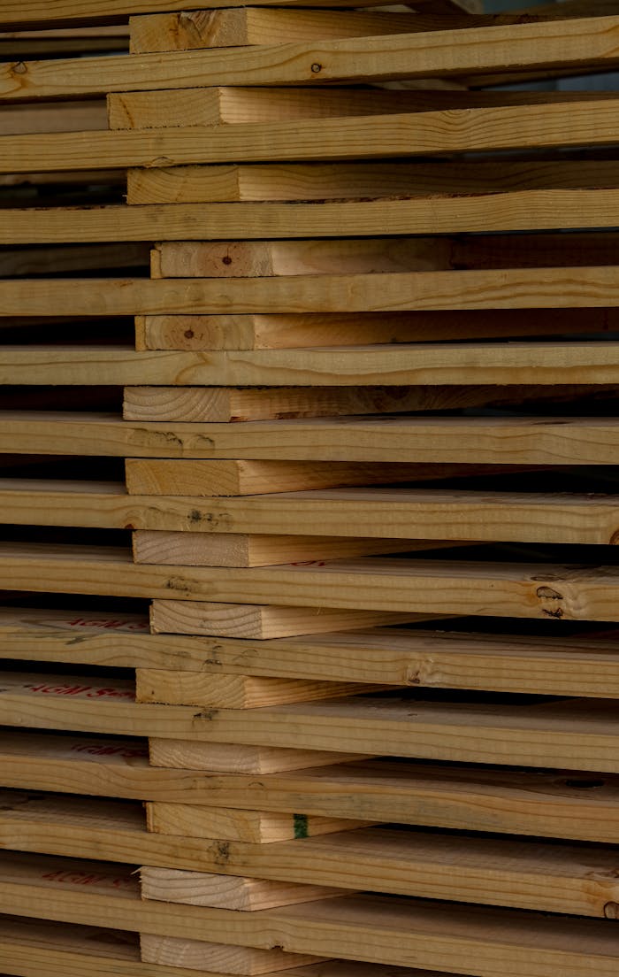 services-06 Detailed close-up of neatly stacked wooden planks, ideal for woodworking and construction themed concepts.