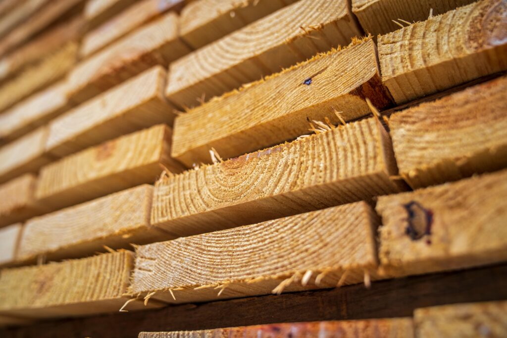 pexels photo 12278589 12278589 Detailed close-up of neatly stacked wooden planks showing textures of natural lumber.