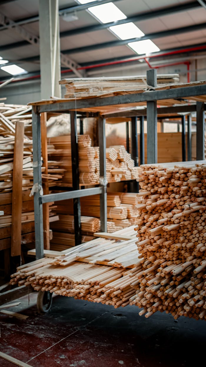 about-us Vertically piled wooden materials neatly arranged in an indoor warehouse setting.