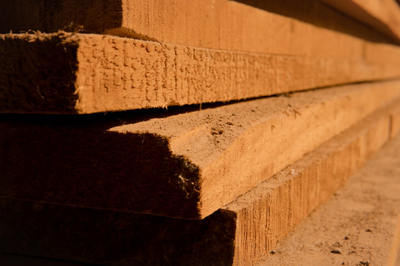 Crafting Captivating Headlines: Your awesome post title goes here Detailed view of stacked wooden planks, highlighting texture and shadows in natural light.