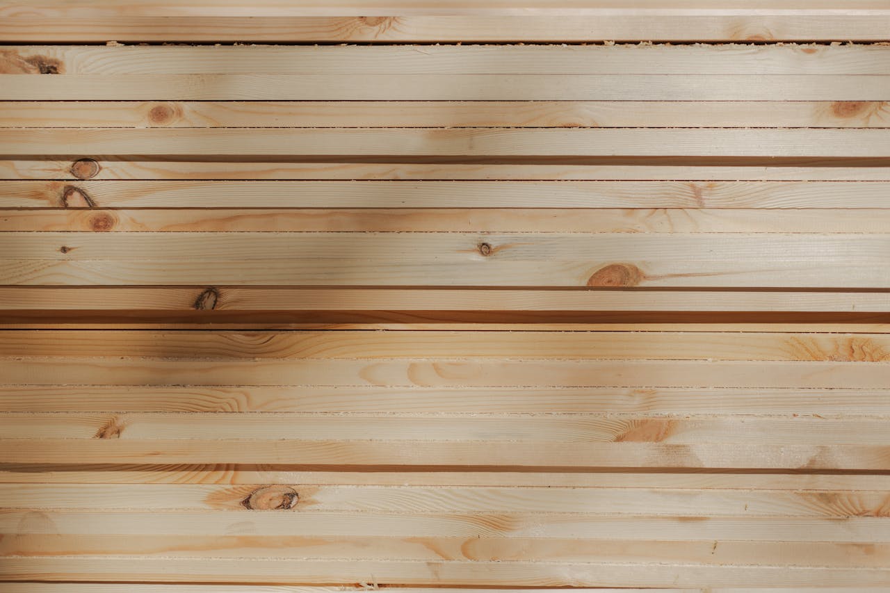 Close-up of stacked timber planks showing natural wood grain and texture.